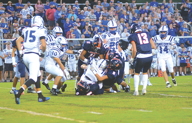 Carlos Anderson (11), William Lowery (5), Braxton Bunch (8) and Josh Guerrant (44) swarmed the Gate City ball carrier. PHOTO BY KELLEY PEARSON