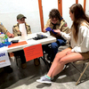 Scout Nick Sturgill performs a blood glucose check on a volunteer while Scout Koleby Bush & Scoutmaster Sam Deel observe.