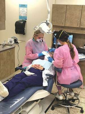 Dr. Olivia Stallard (left) and Taylor Perry (right) conducting an oral examination.  